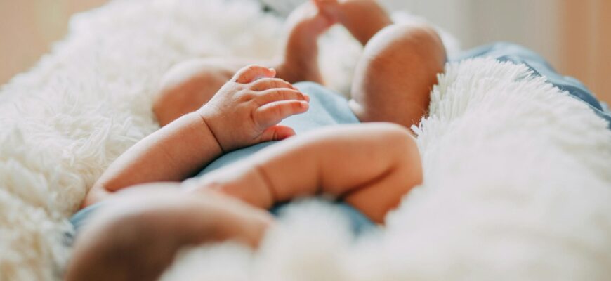photo of baby laying on fleece blanket