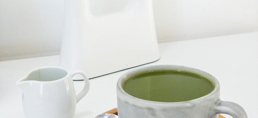 photo of white ceramic cup on wooden tray