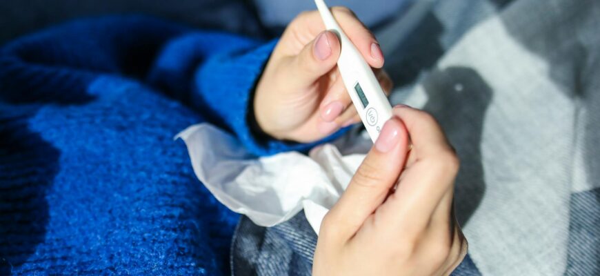 person holding thermometer