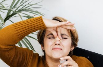 hurt woman holding the bridge of her nose