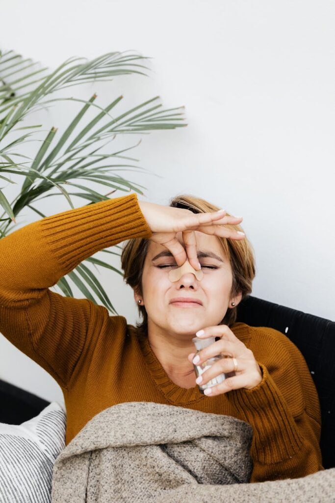 hurt woman holding the bridge of her nose