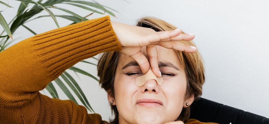 hurt woman holding the bridge of her nose
