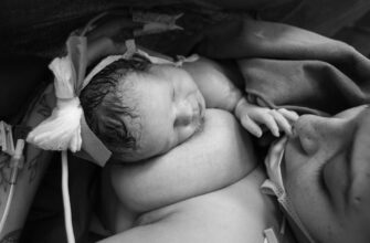woman having skin to skin contact with her newborn baby