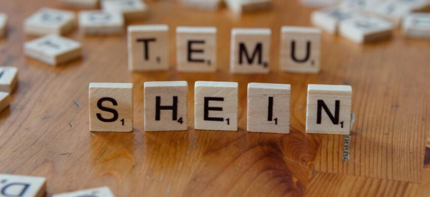 scrabble tiles spelling temu shein on wooden table