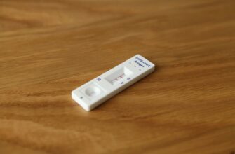 a white remote control sitting on top of a wooden table