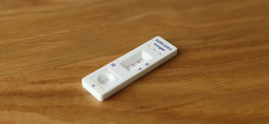 a white remote control sitting on top of a wooden table
