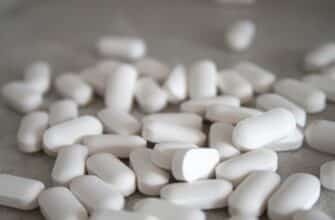 white medication pills on brown surface