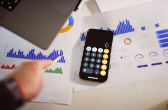 a calculator sitting on top of a table next to a laptop