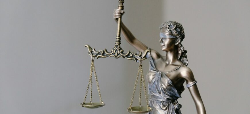 woman in dress holding sword figurine