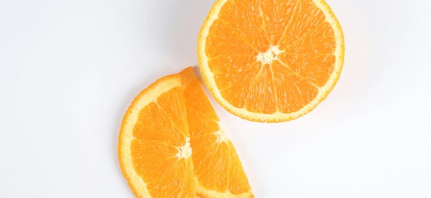 sliced orange fruit on white surface