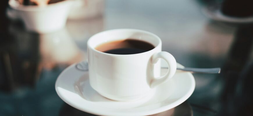 cup of coffee on white ceramic saucer