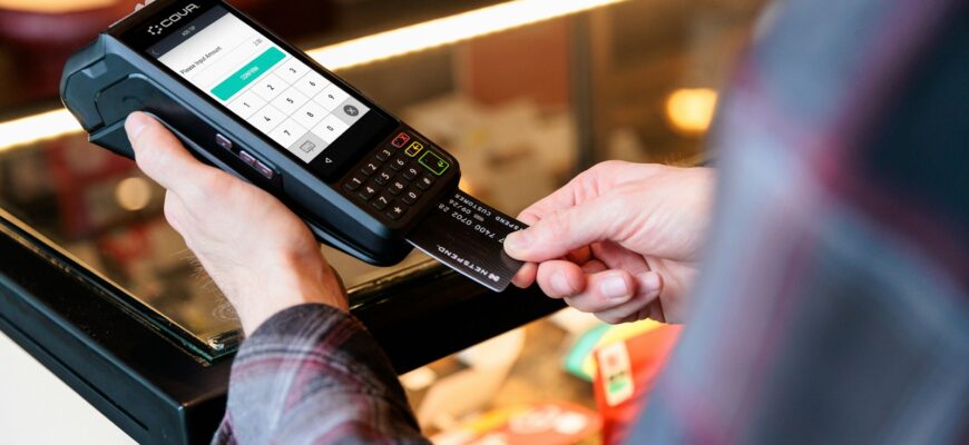 a person holding a cell phone in their hand