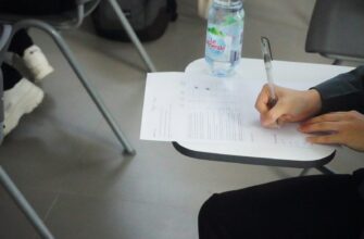 a person writing on a piece of paper