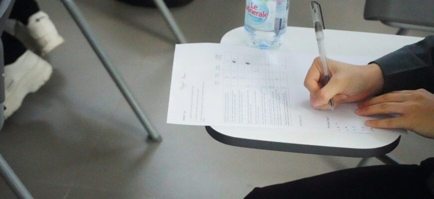 a person writing on a piece of paper