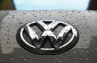 water dew on silver Volkswagen car emblem