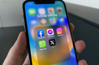 a person holding a cell phone with social media on the screen