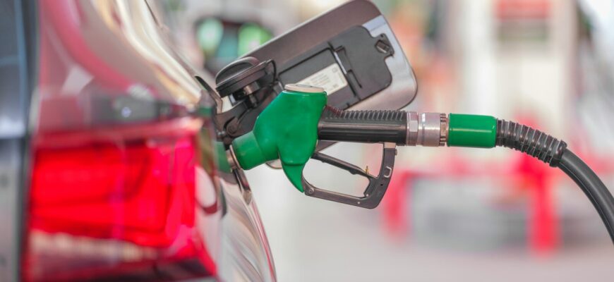 a gas pump is connected to a car at a gas station
