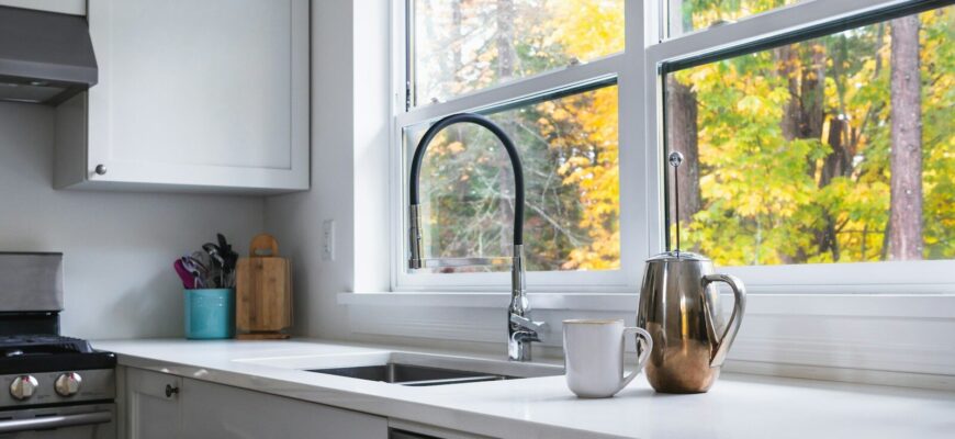 a kitchen with a sink, stove and a window