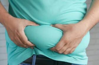 a man holding his stomach with his hands