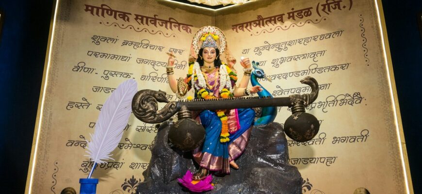 Goddess saraswati statue holding a veena with a peacock.